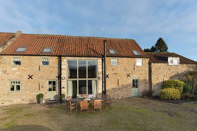 The beautifully converted barn exterior of Mill House in Yorkshire