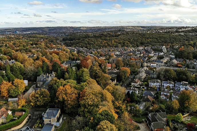 A bird's eye view of Sheffield with lots of woodland in amongst the buildings